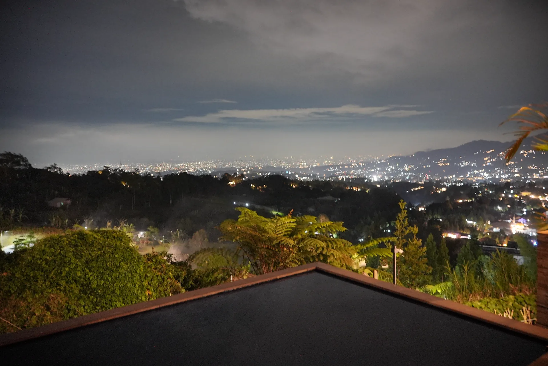 Private pool at night above the city lights