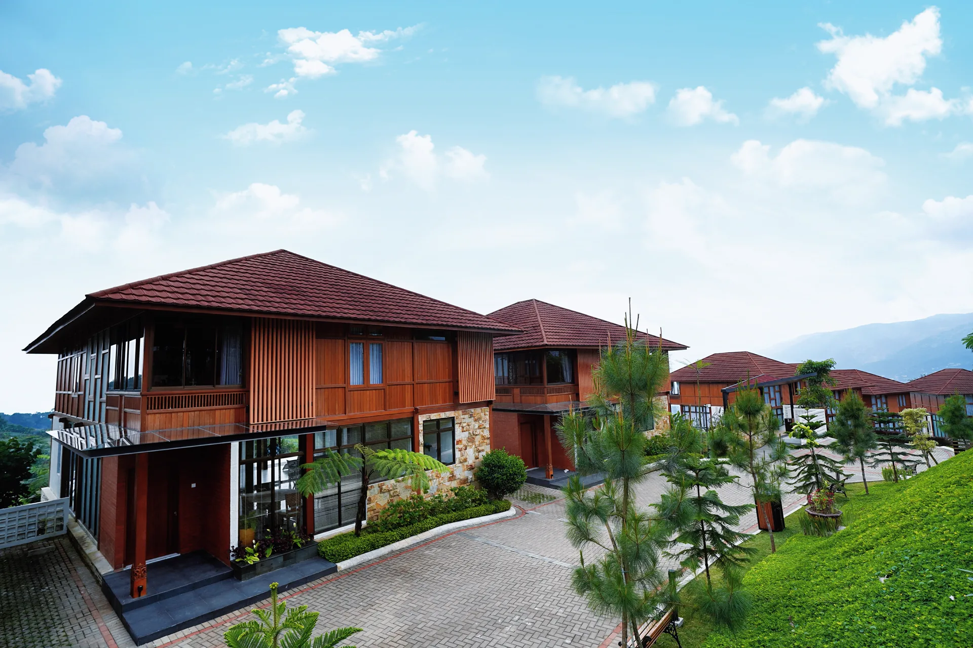 Timber villas below the mountains on a clear day